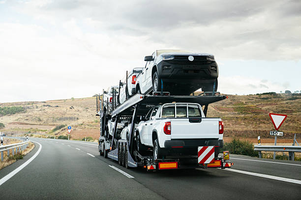 A truck transporting pick-up trucks on a highway